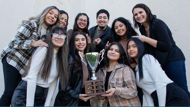 Members of the LUNA club holding a trophy